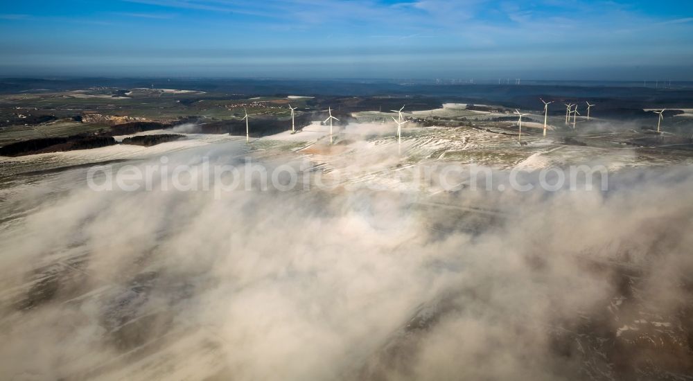 Brilon from above - Wind power plants in Roesenbeck in wintry landscape verscheneiter in North Rhine-Westphalia, Germany