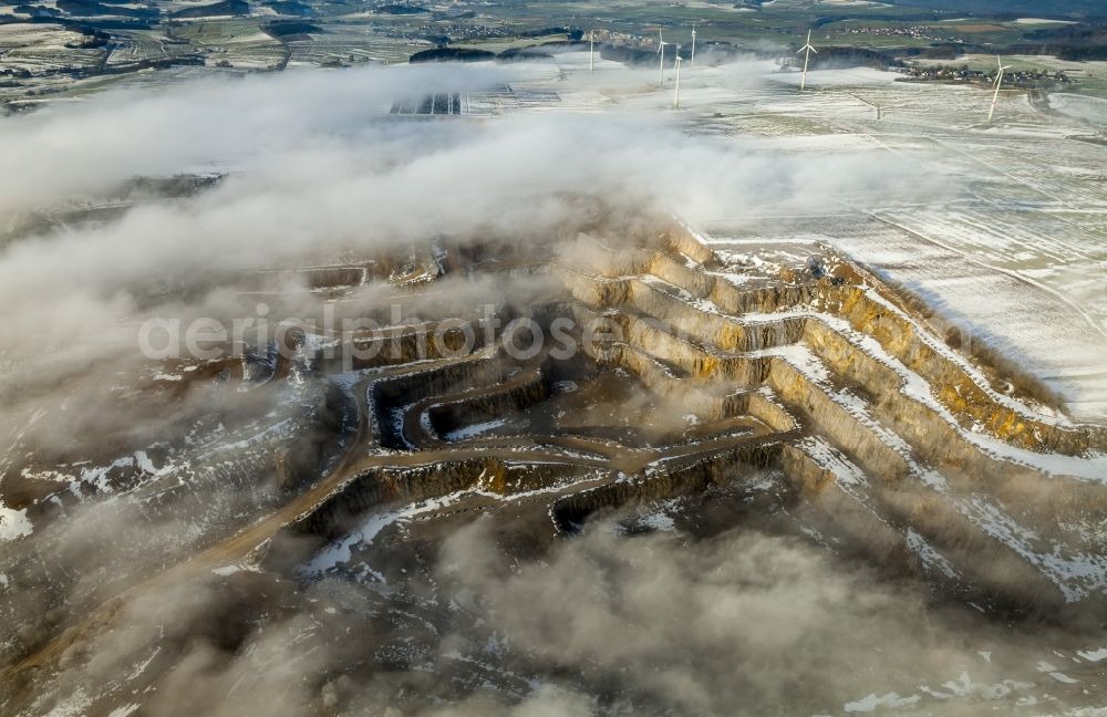 Brilon from the bird's eye view: Wind power plants in Roesenbeck in wintry landscape verscheneiter in North Rhine-Westphalia, Germany