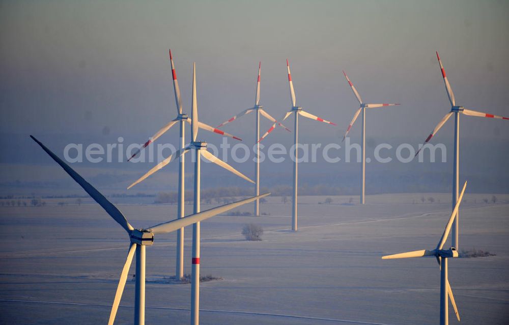 Aerial image Badeleben - Winterlich mit Schnee bedeckter Windpark in der Nähe des Ortsteils Badeleben der Gemeinde Völpke im Landkreis Börde in Sachsen-Anhalt. Ein Projekt der WindStrom Energieanlagen GmbH & Co. KG WindStrom GbR. The wind farm / wind park / wind power station near to urban district Badeleben of the administrative district Boerde in Saxony-Anhalt. A project of WindStrom Energieanlagen GmbH & Co. KG WindStrom GbR.