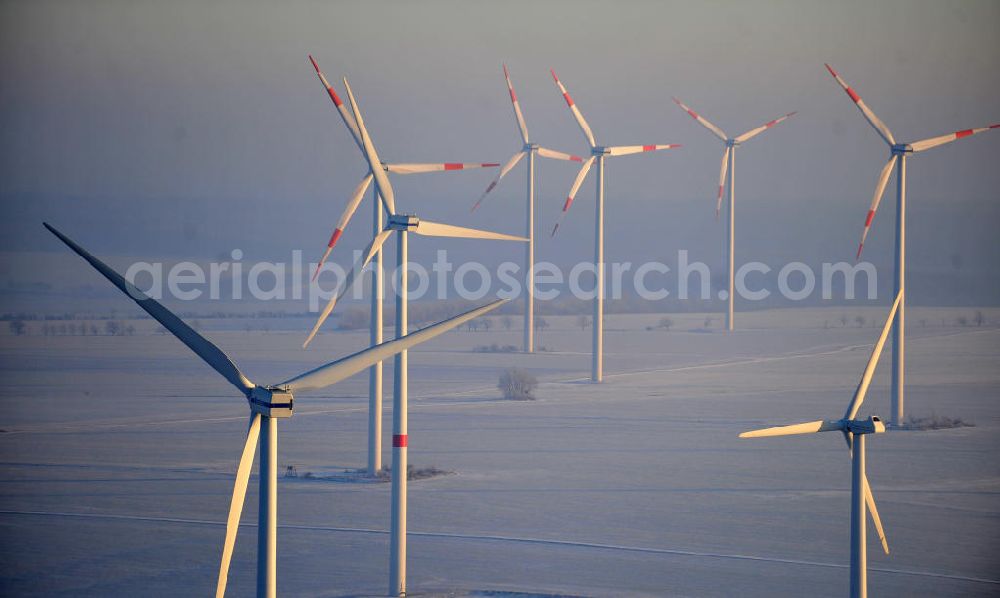 Aerial photograph Badeleben - Winterlich mit Schnee bedeckter Windpark in der Nähe des Ortsteils Badeleben der Gemeinde Völpke im Landkreis Börde in Sachsen-Anhalt. Ein Projekt der WindStrom Energieanlagen GmbH & Co. KG WindStrom GbR. The wind farm / wind park / wind power station near to urban district Badeleben of the administrative district Boerde in Saxony-Anhalt. A project of WindStrom Energieanlagen GmbH & Co. KG WindStrom GbR.