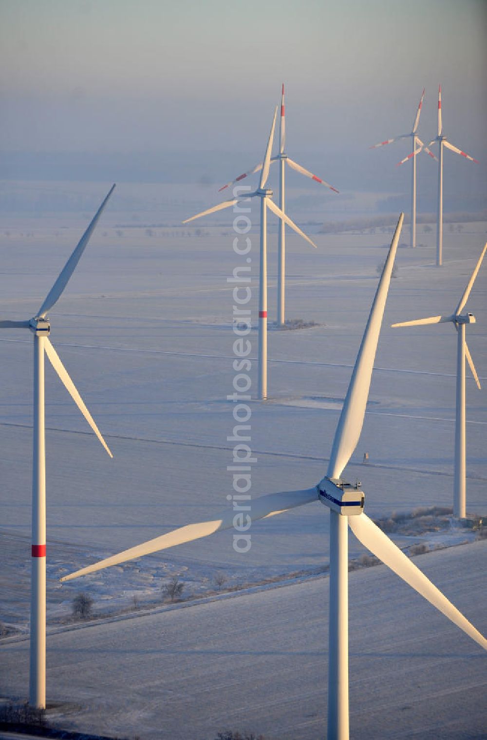 Badeleben from the bird's eye view: Winterlich mit Schnee bedeckter Windpark in der Nähe des Ortsteils Badeleben der Gemeinde Völpke im Landkreis Börde in Sachsen-Anhalt. Ein Projekt der WindStrom Energieanlagen GmbH & Co. KG WindStrom GbR. The wind farm / wind park / wind power station near to urban district Badeleben of the administrative district Boerde in Saxony-Anhalt. A project of WindStrom Energieanlagen GmbH & Co. KG WindStrom GbR.