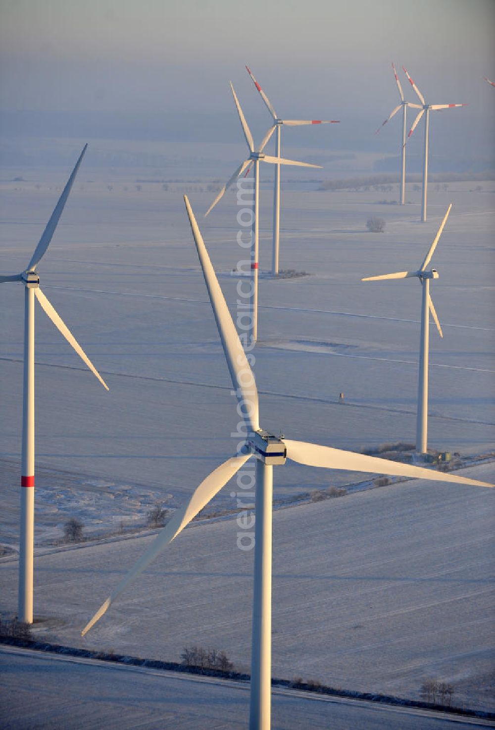 Aerial image Badeleben - Winterlich mit Schnee bedeckter Windpark in der Nähe des Ortsteils Badeleben der Gemeinde Völpke im Landkreis Börde in Sachsen-Anhalt. Ein Projekt der WindStrom Energieanlagen GmbH & Co. KG WindStrom GbR. The wind farm / wind park / wind power station near to urban district Badeleben of the administrative district Boerde in Saxony-Anhalt. A project of WindStrom Energieanlagen GmbH & Co. KG WindStrom GbR.