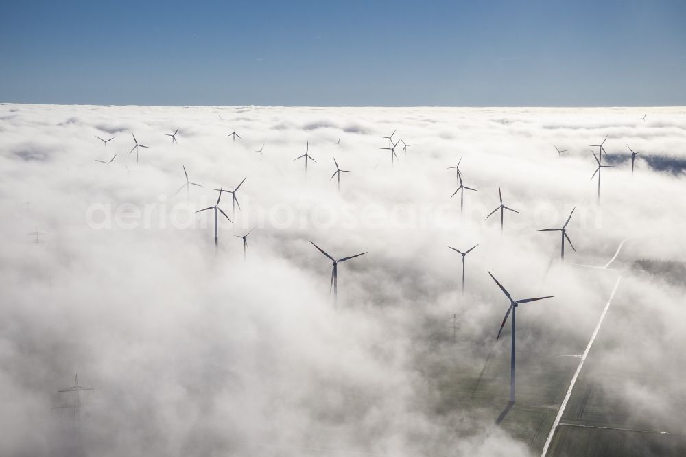 Aerial photograph Bad Wünnenberg - Wind turbines projecting from a fog layer and clouds Wind power plant at Bad Wünnenberg in the Sauerland region in North Rhine-Westphalia