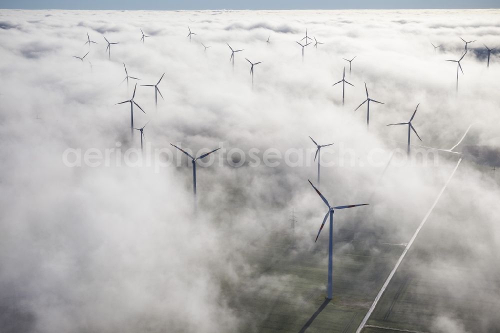 Bad Wünnenberg from above - Wind turbines projecting from a fog layer and clouds Wind power plant at Bad Wünnenberg in the Sauerland region in North Rhine-Westphalia