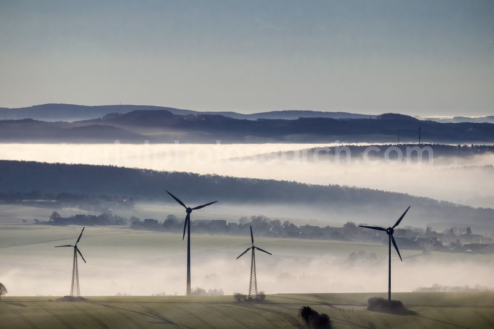 Aerial image Ense - Wind turbines projecting from a fog layer and clouds Wind power plant near Ense in the Sauerland region in North Rhine-Westphalia