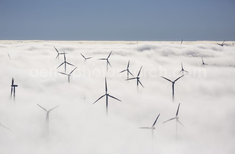 Aerial photograph Marsberg - Wind turbines projecting from a fog layer and clouds Wind power plant at Marsberg in the Sauerland region in North Rhine-Westphalia