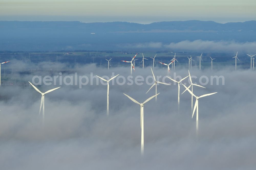 Aerial image Marsberg - Wind turbines projecting from a fog layer and clouds Wind power plant at Marsberg in the Sauerland region in North Rhine-Westphalia