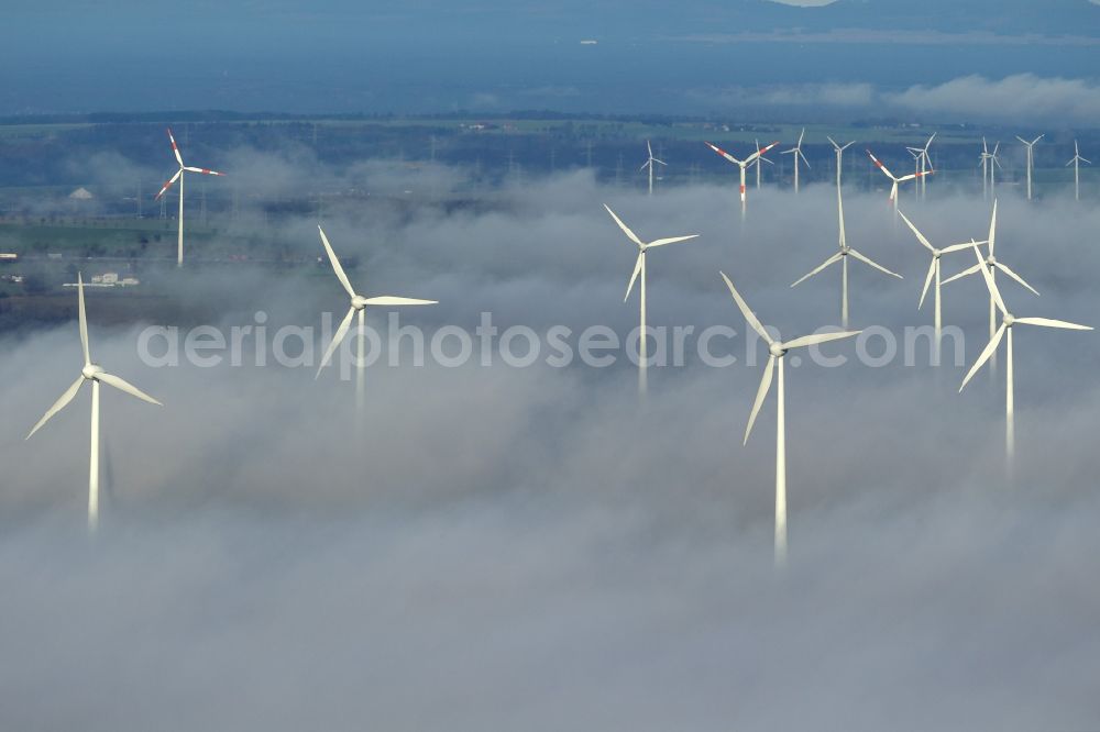 Aerial photograph Marsberg - Wind turbines projecting from a fog layer and clouds Wind power plant at Marsberg in the Sauerland region in North Rhine-Westphalia