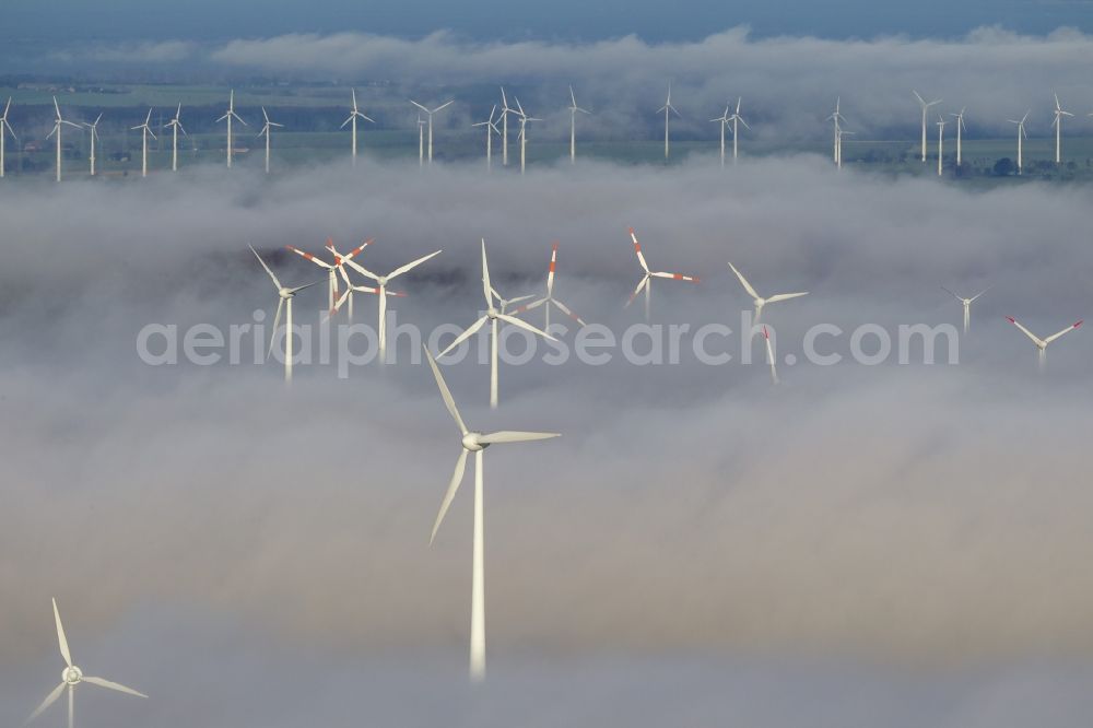 Aerial image Marsberg - Wind turbines projecting from a fog layer and clouds Wind power plant at Marsberg in the Sauerland region in North Rhine-Westphalia