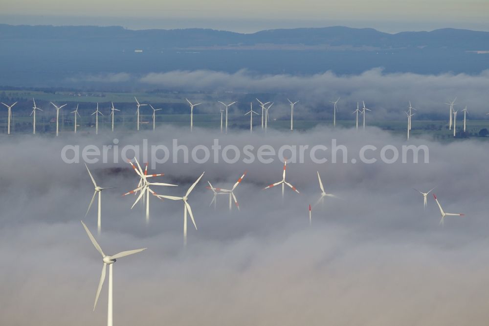 Aerial photograph Marsberg - Wind turbines projecting from a fog layer and clouds Wind power plant at Marsberg in the Sauerland region in North Rhine-Westphalia