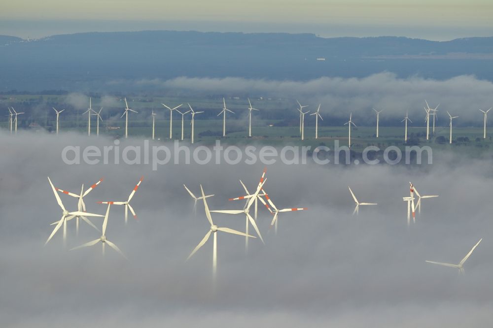 Marsberg from the bird's eye view: Wind turbines projecting from a fog layer and clouds Wind power plant at Marsberg in the Sauerland region in North Rhine-Westphalia