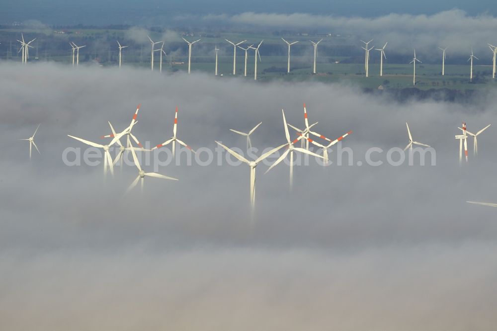 Aerial image Marsberg - Wind turbines projecting from a fog layer and clouds Wind power plant at Marsberg in the Sauerland region in North Rhine-Westphalia