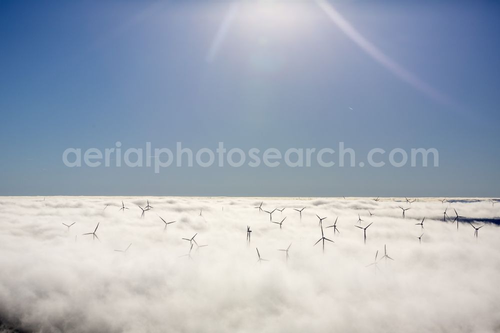 Aerial photograph Marsberg - Wind turbines projecting from a fog layer and clouds Wind power plant at Marsberg in the Sauerland region in North Rhine-Westphalia