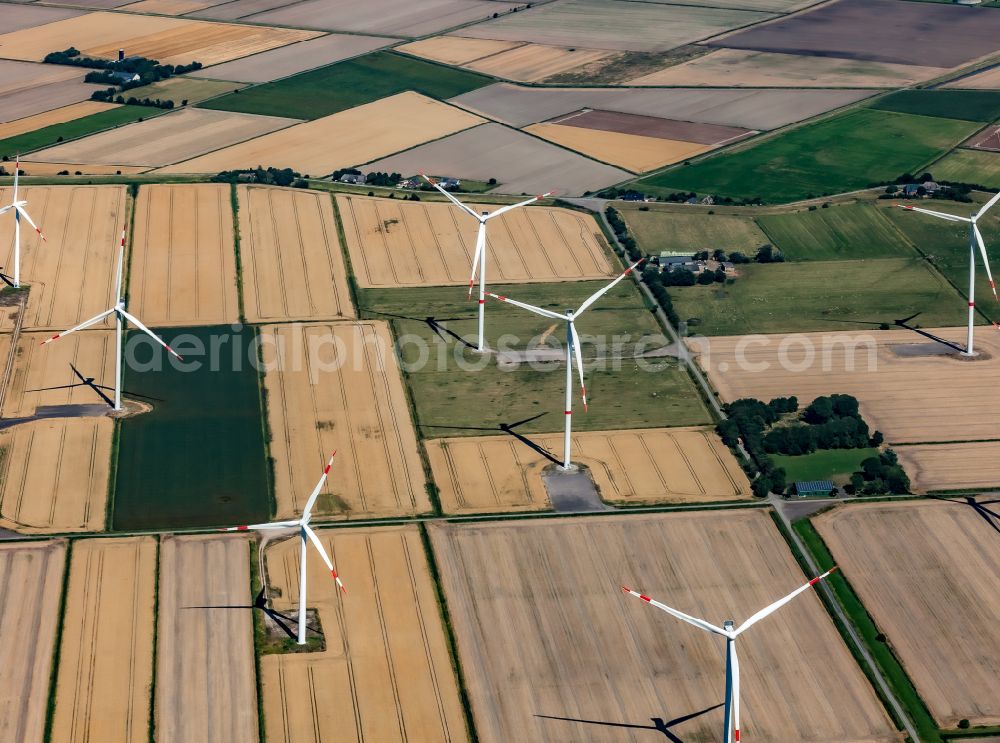 Dagebüll from the bird's eye view: Wind turbines of a wind power plant on agricultural land and fields on the street Kreuzweg in Dagebuell North Friesland in the state Schleswig-Holstein, Germany