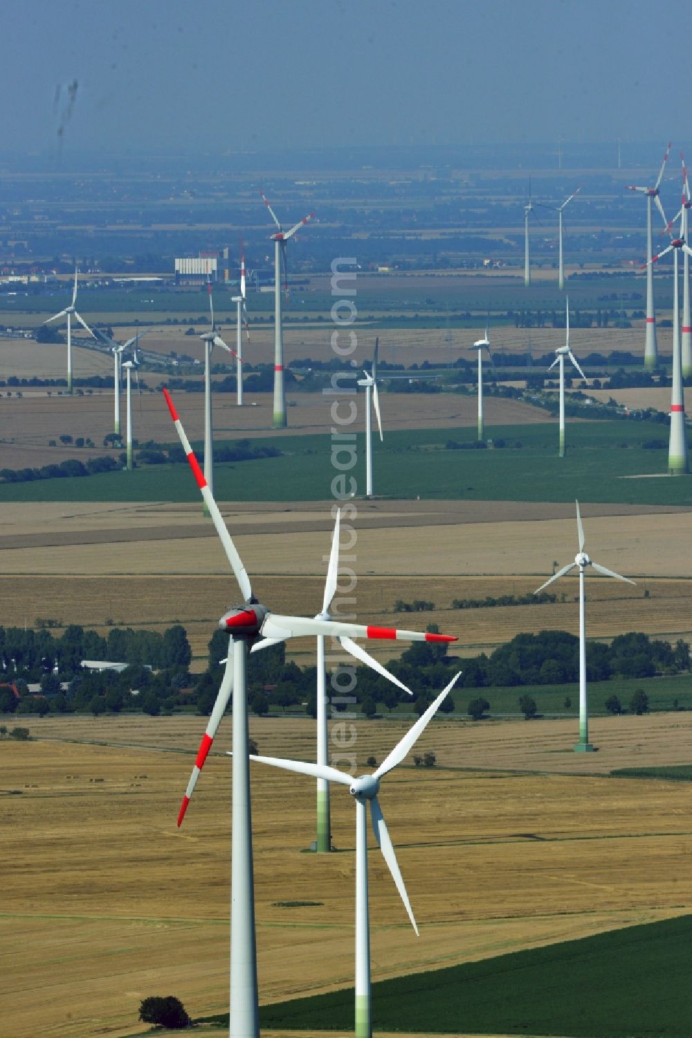 Löbitz from the bird's eye view: Wind turbines of the wind power plants on fields at Loebitz in the state of Saxony-Anhalt