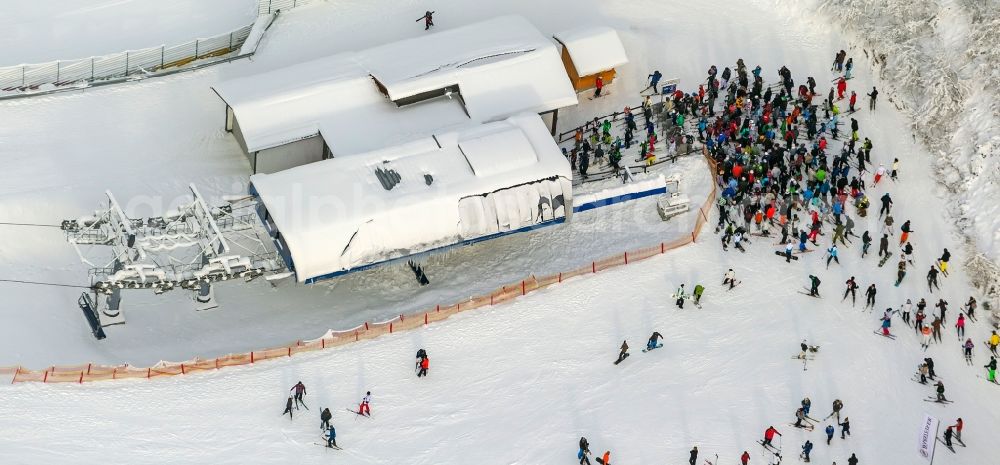 Aerial photograph Winterberg - Winter - View of the slope covered with snow, and snow skiing site with apres-ski - rest stop in Winterberg in North Rhine-Westphalia NRW