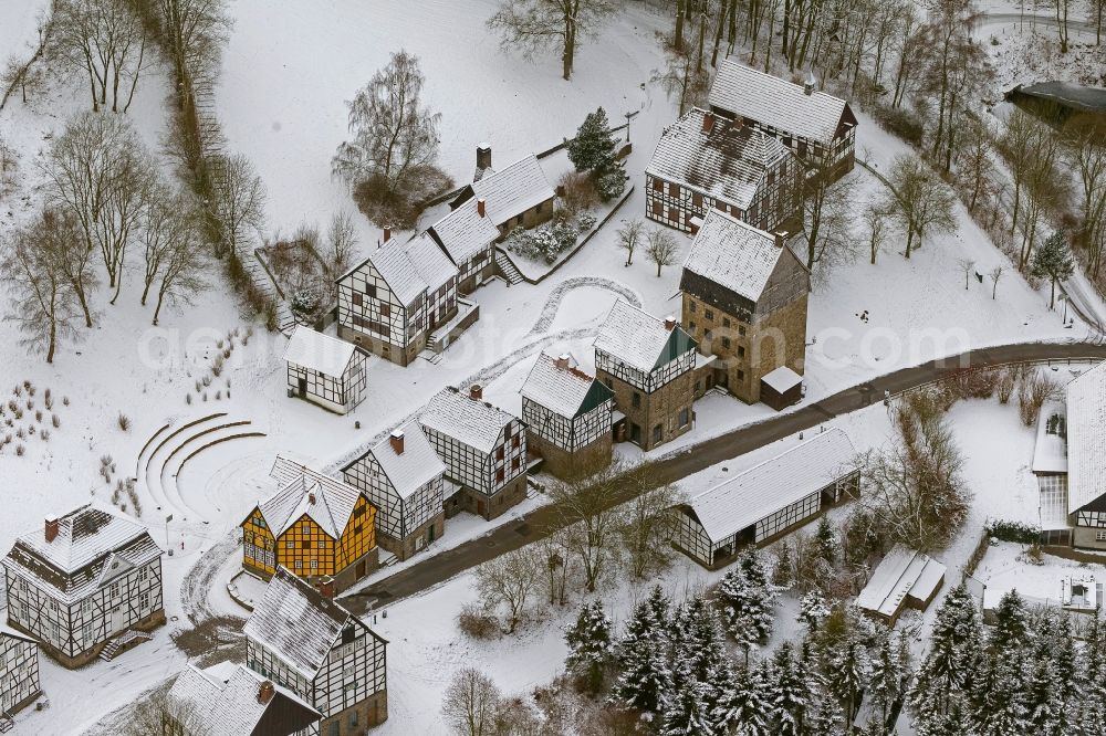 Aerial photograph Hagen - Winter - landscape of snow-covered terrain of the open-air museum Hagen. The Westphalian State Museum of craft and technology is an open air museum in the Hagen district Selbecke Mäckingerbachtal in the southeastern Ruhr area in North Rhine-Westphalia. Carrier is the Regional Association of Westphalia-Lippe