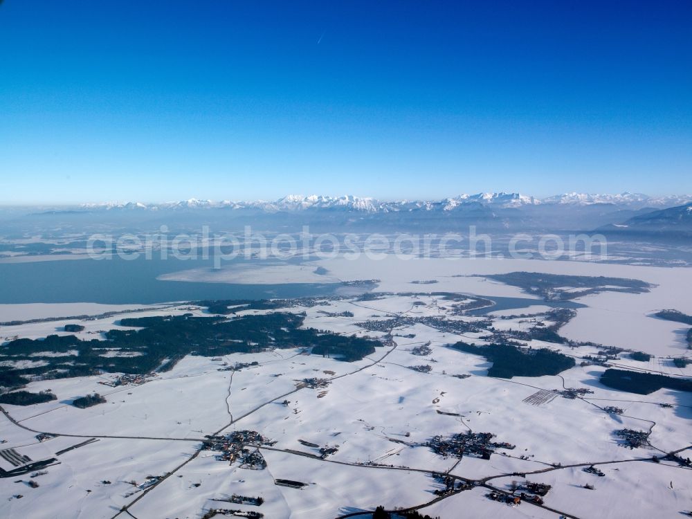 Inzell from the bird's eye view: Winter - Landscape with snowy fields of the Chiemgau before the panorama of the Alps - mountains on the horizon at Inzell in Bavaria