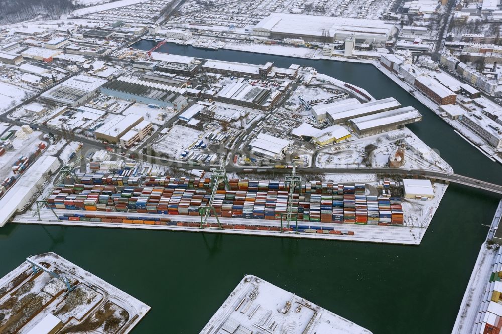 Dortmund from the bird's eye view: Winter - Aerial view of snow-covered terrain of the inland port to the seat of the disposal company Envio in Dortmund in North Rhine-Westphalia. In the largest toxic waste scandal in the country to the recycling company Envio have poisoned over the years employees and residents in Dortmund with carcinogenic PCBs