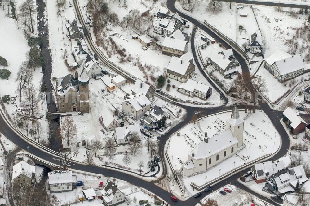 Olsberg from the bird's eye view: Winter - Local view of snow-covered city on the Bruns Kappeler church and the castle Wildenberg Olsberg Sauerland in North Rhine-Westphalia NRW