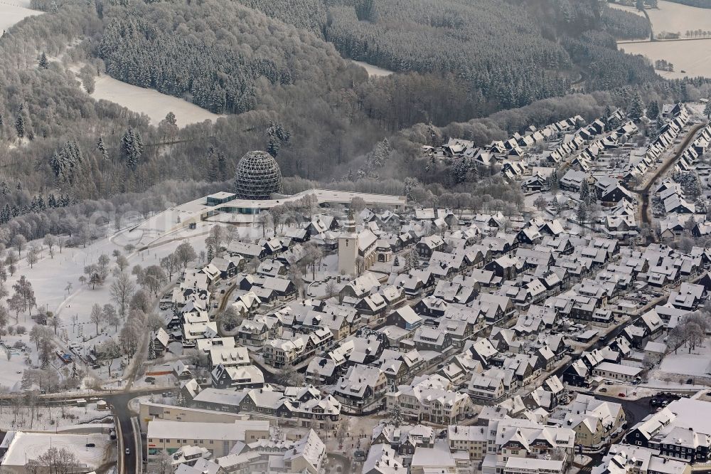 Winterberg from above - Winter city view from the snow-covered city center to the tourist center Oversum in Winterberg in North Rhine-Westphalia NRW. The Oversum Vital Resort Winterberg is a hotel - complex with gym and spa