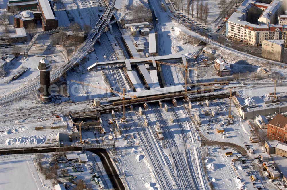 Aerial image Berlin - Wintereinbruch beim Um- und Neubau des Berliner S-Bahnhofs Ostkreuz. Trotz Schnee laufen die Arbeiten weiter. Der Bahnhof wurde bereits im Jahr 1882 eröffnet und ist somit stark sanierungsbedürftig. Teile der Neubauten führt die EUROVIA Beton GmbH aus. Weiterhin beteiligt ist das Unternehmen VEPRO Verkehrsbauprojekt GmbH. Kontakt EUROVIA: EUROVIA BEton GmbH, Niederlassung Ingenieurbau und Zweigniederlassung Cottbus, Gewerbeparkstraße 17, 03099 Kolkwitz, Tel. +49(0)355 35552 3, Fax +49(0)355 35552 52, EMail: ingenieurbau@eurovia.de; Kontakt VEPRO: Verkehrsbau Projekt GmbH, Storkower Str. 132, 10407 Berlin, Tel. +49(0)30 42194 0, Fax +49(0)30 42194 221