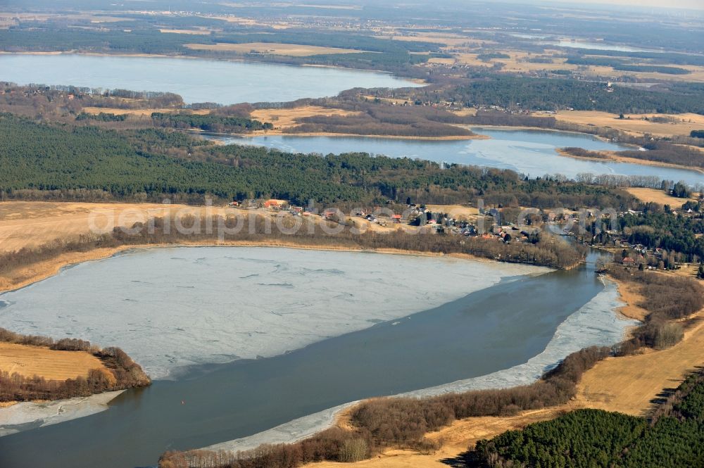 Heidesee OT Gussow from the bird's eye view: View of the winter covered in snow and frozen Dolgensee near Gussow in the state of Brandenburg