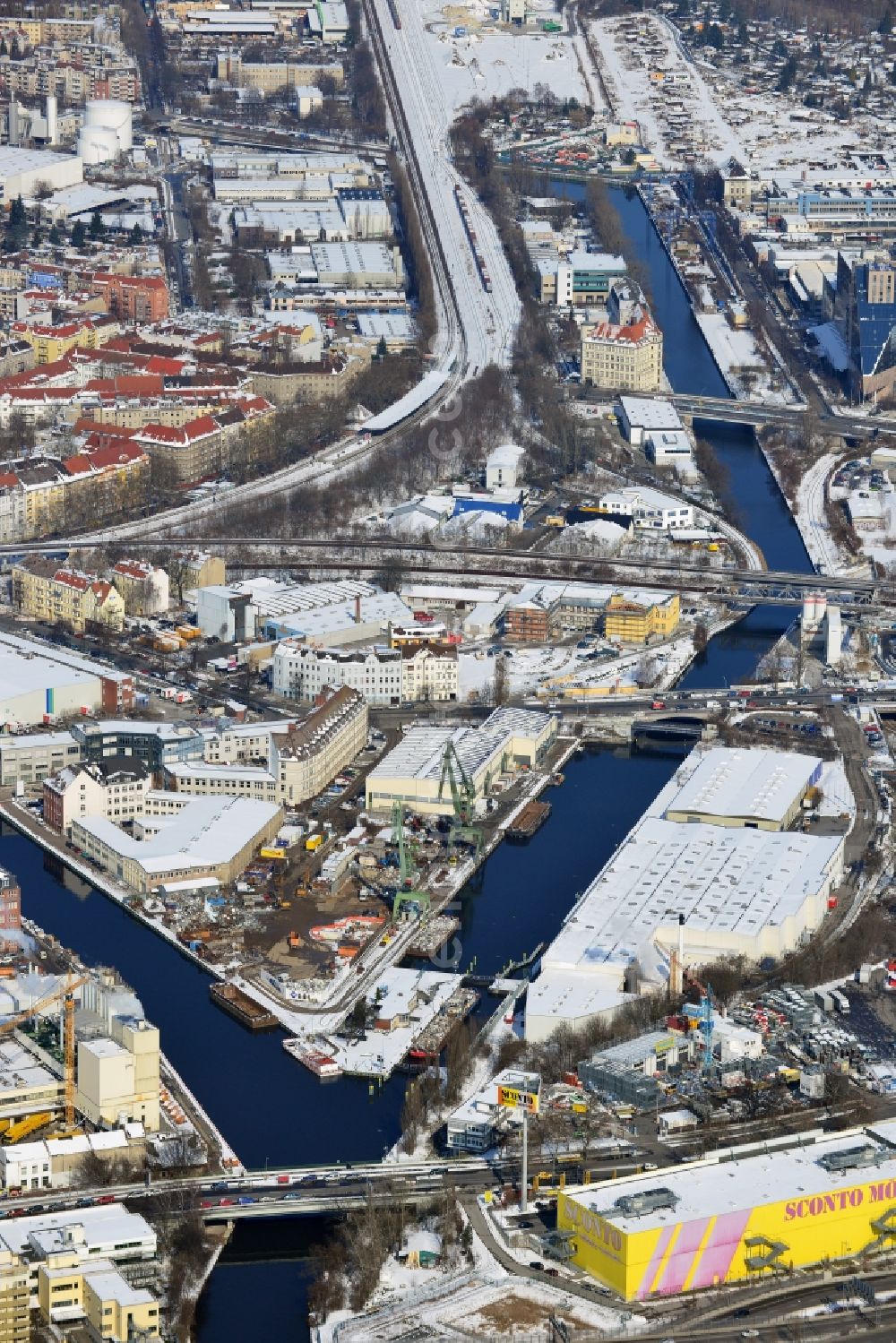 Berlin Neukölln from above - Winter with snow covered grounds of the harbor and the lock Neukölln between the upper and lower harbor, a project of the BEHALA - Berlin port and warehouse mbH