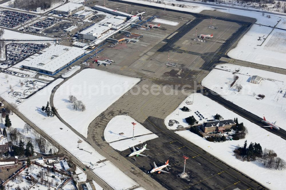 Schönefeld from above - Winter covered with snow runways, taxiways, terminal building and old DDR terminal from INTERFLUG times at Berlin - Schonefeld