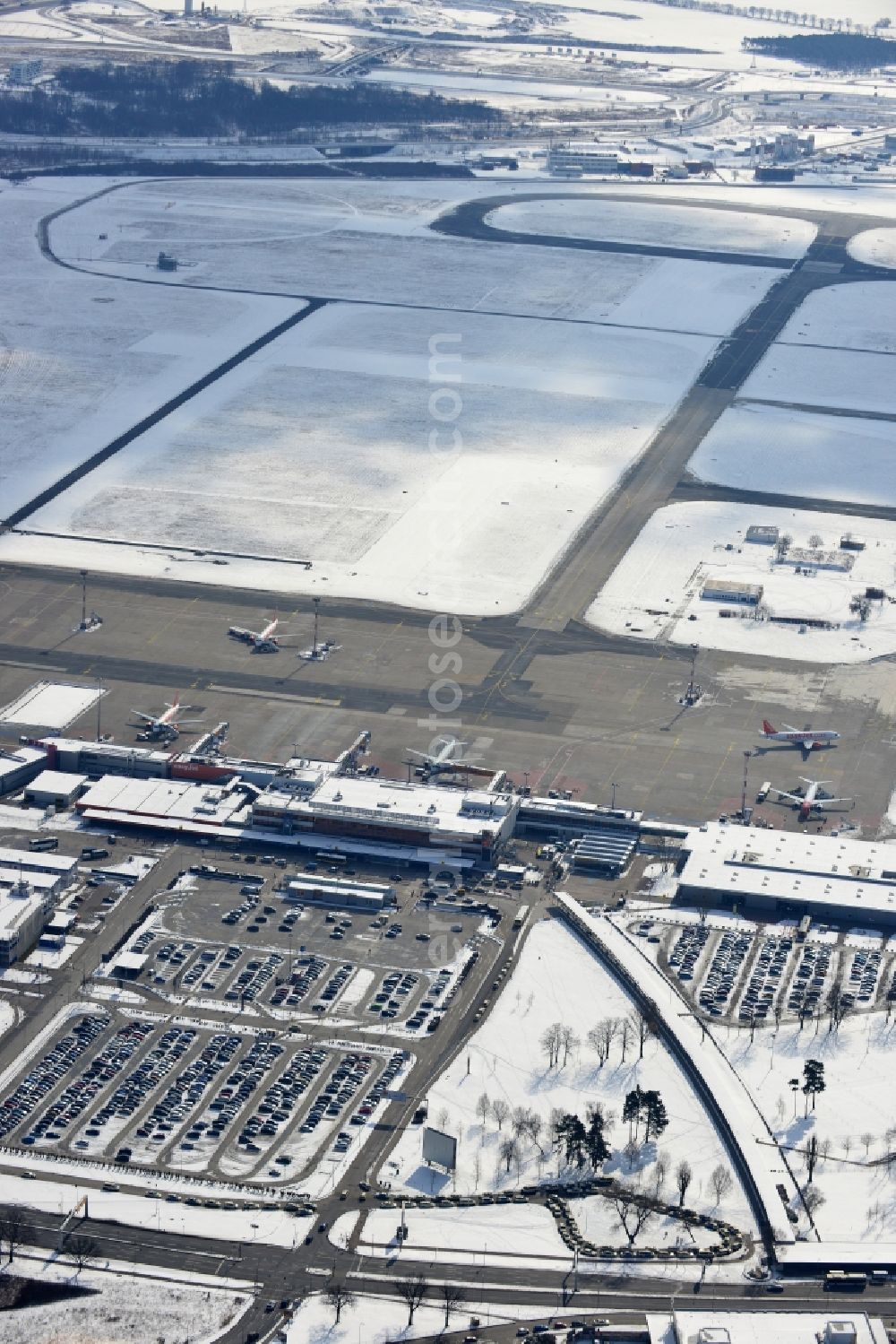 Schönefeld from above - Winter covered with snow runways, taxiways, terminal building and old DDR terminal from INTERFLUG times at Berlin - Schonefeld