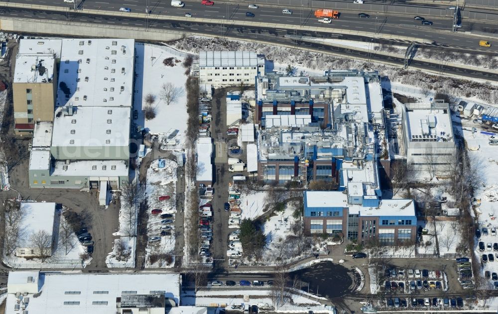 Berlin Neukölln from above - Winter with snow covered grounds of the BIOTRONIK SE & Co. KG at the Woermannkehre in Berlin Neukölln