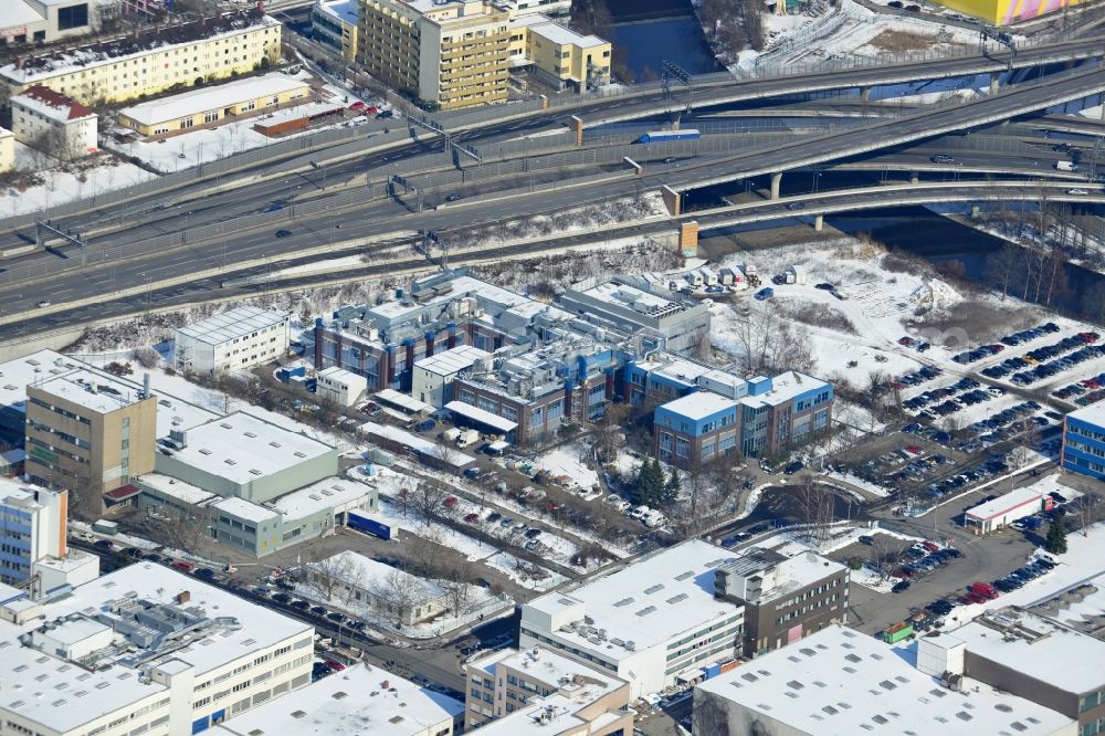 Aerial image Berlin Neukölln - Winter with snow covered grounds of the BIOTRONIK SE & Co. KG at the Woermannkehre in Berlin Neukölln