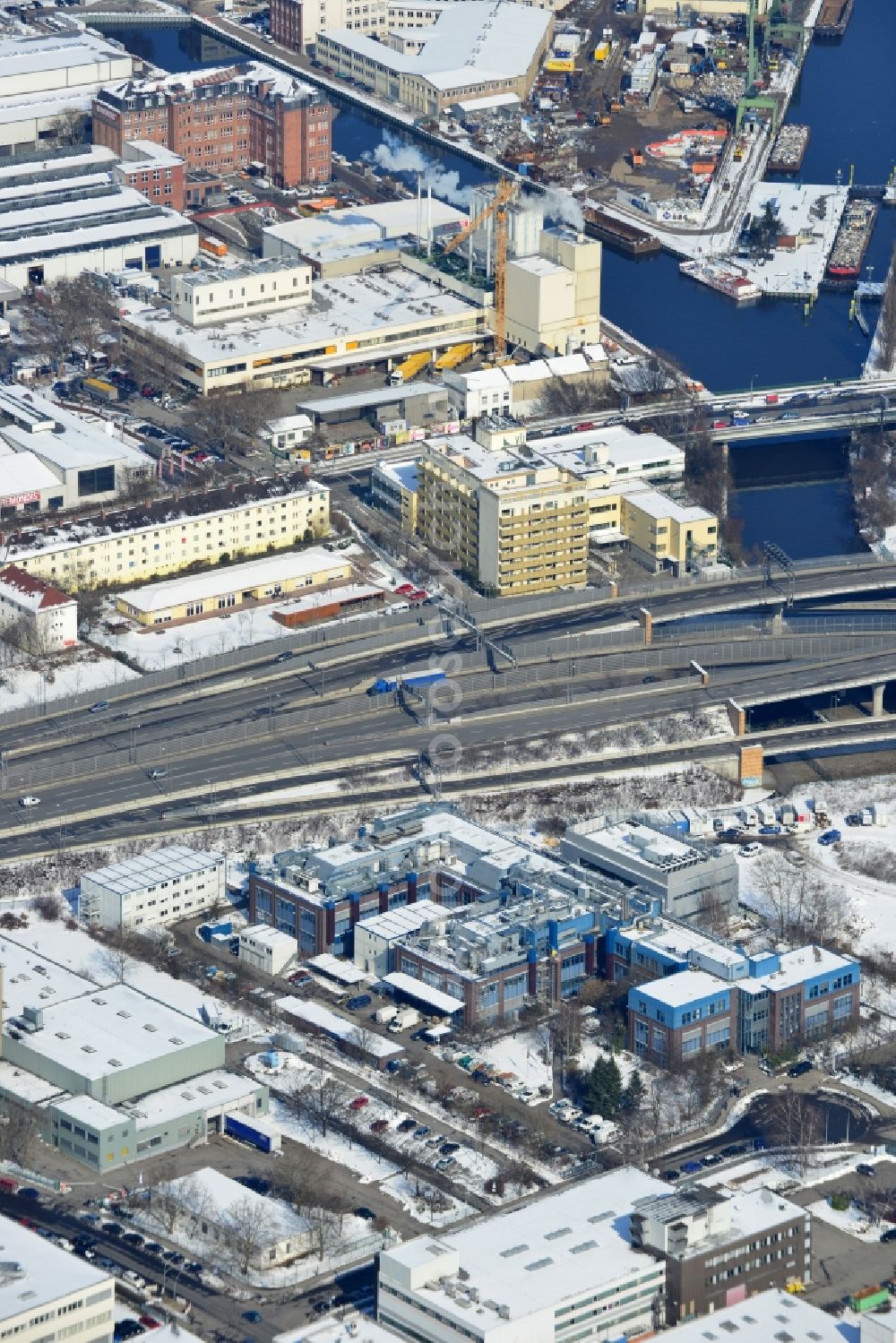 Berlin Neukölln from above - Winter with snow covered grounds of the BIOTRONIK SE & Co. KG at the Woermannkehre in Berlin Neukölln