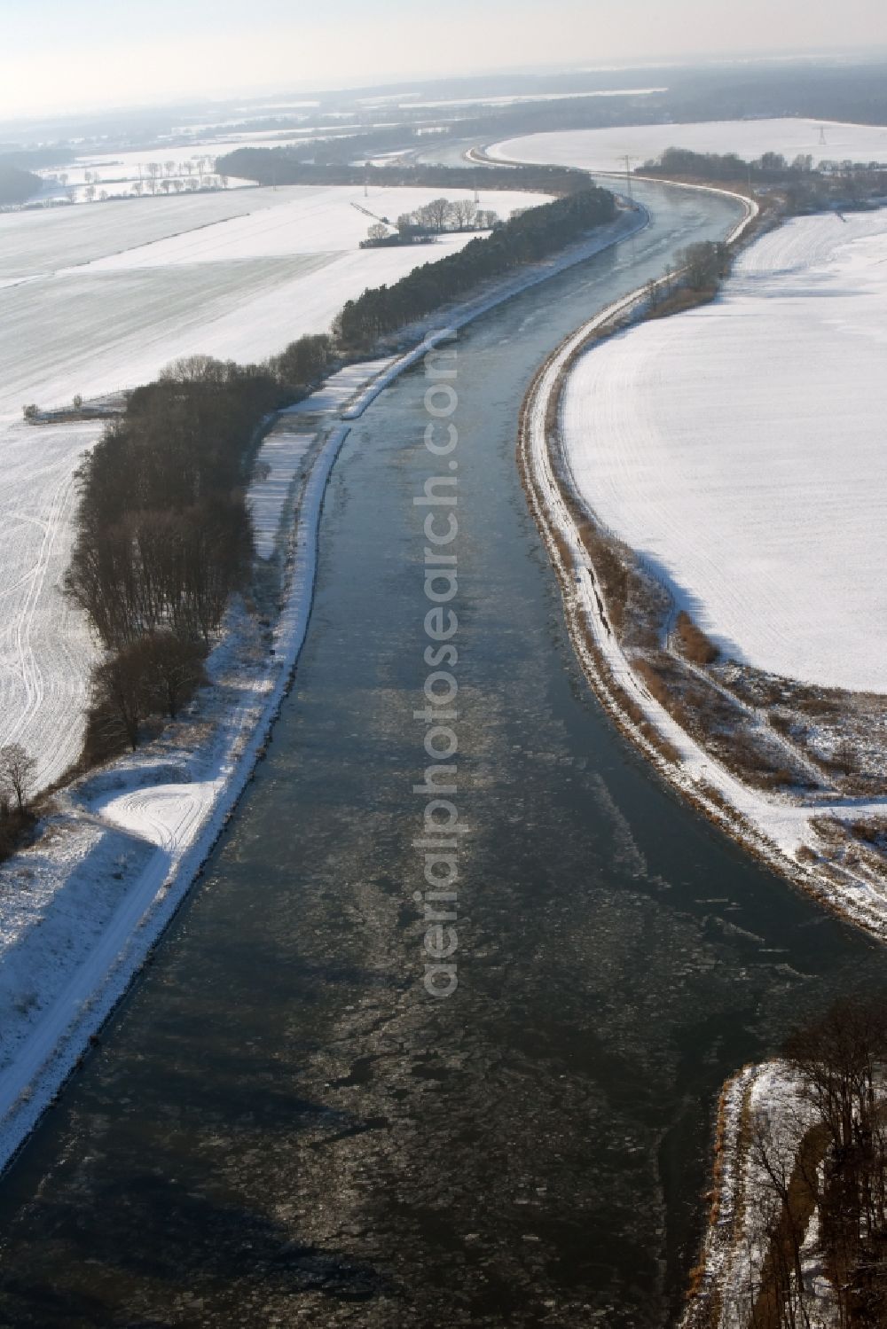 Genthin from above - Wintry covered with snow and ice flux flow of the Elbe-Havel Canal in Genthin in the state of Saxony-Anhalt