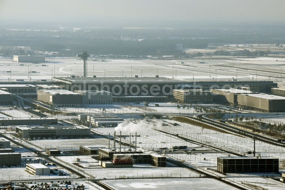 Schönefeld from above - Wintry snowy dispatch building and terminals on the premises of the airport BER in Schoenefeld in the state Brandenburg