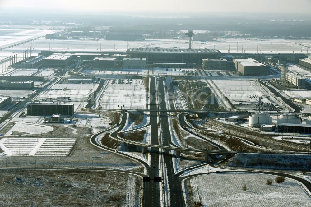 Schönefeld from the bird's eye view: Wintry snowy dispatch building and terminals on the premises of the airport BER in Schoenefeld in the state Brandenburg