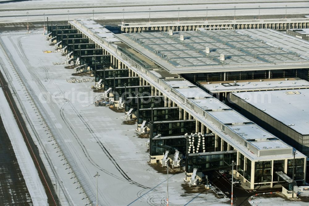 Aerial image Schönefeld - Wintry snowy dispatch building and terminals on the premises of the airport BER in Schoenefeld in the state Brandenburg