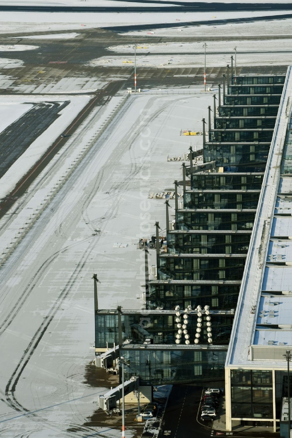 Aerial image Schönefeld - Wintry snowy dispatch building and terminals on the premises of the airport BER in Schoenefeld in the state Brandenburg