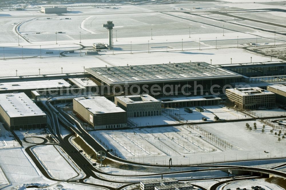 Schönefeld from above - Wintry snowy dispatch building and terminals on the premises of the airport BER in Schoenefeld in the state Brandenburg