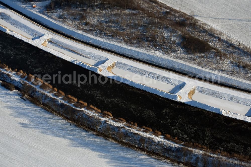 Aerial photograph Ihleburg - Wintry snowy disposal sites on the banks of the Elbe-Havel canal at Ihleburg in Saxony-Anhalt