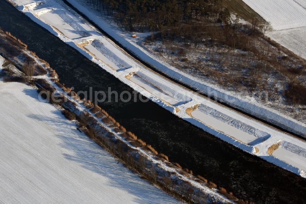 Ihleburg from above - Wintry snowy disposal sites on the banks of the Elbe-Havel canal at Ihleburg in Saxony-Anhalt