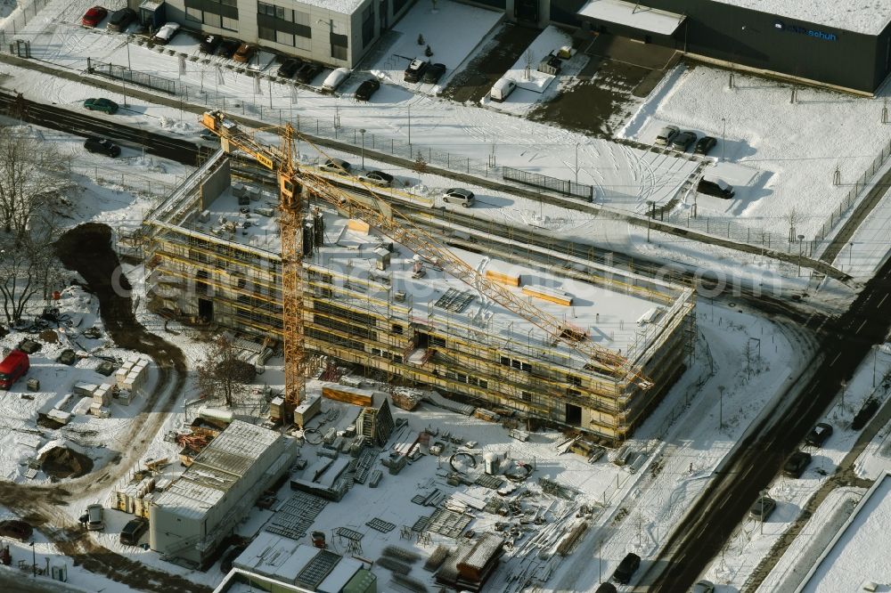 Berlin from above - Snow-covered construction site for a new building at the ifp Institute for Product Quality in the technology park of Adlershof in Berlin in Germany