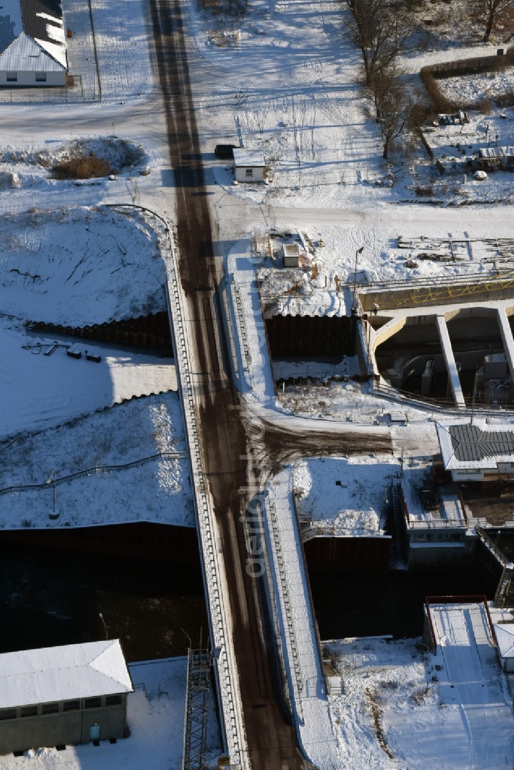 Aerial image Zerben - Wintry snowy construction site at the Zerben sluice, bridge and the riverside of the Elbe-Havel-Canel in the state Saxony-Anhalt