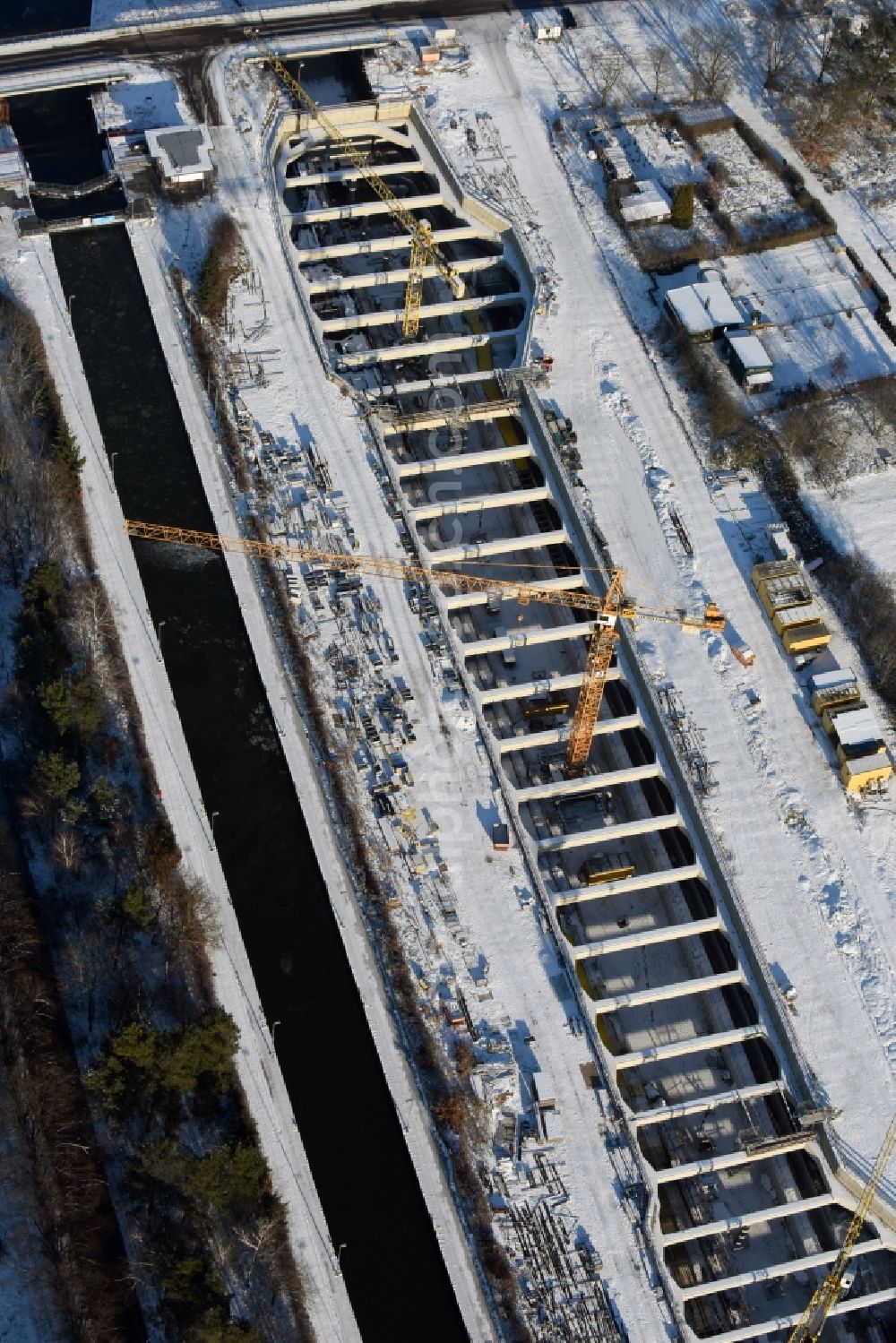 Aerial image Zerben - Wintry snowy construction site at the Zerben sluice, bridge and the riverside of the Elbe-Havel-Canel in the state Saxony-Anhalt