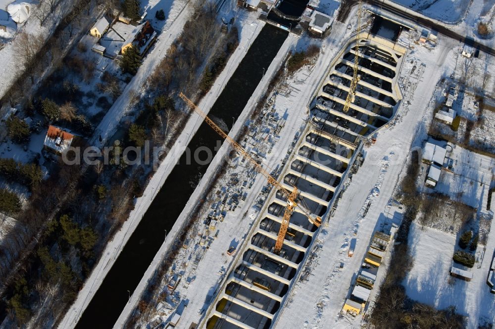 Zerben from above - Wintry snowy construction site at the Zerben sluice, bridge and the riverside of the Elbe-Havel-Canel in the state Saxony-Anhalt