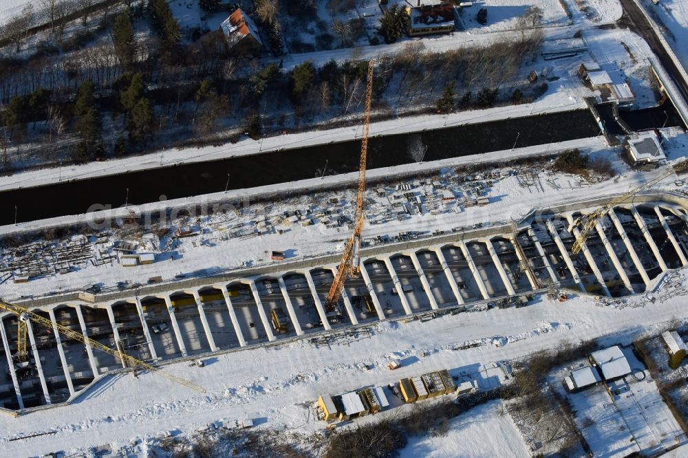 Aerial image Zerben - Wintry snowy construction site at the Zerben sluice, bridge and the riverside of the Elbe-Havel-Canel in the state Saxony-Anhalt