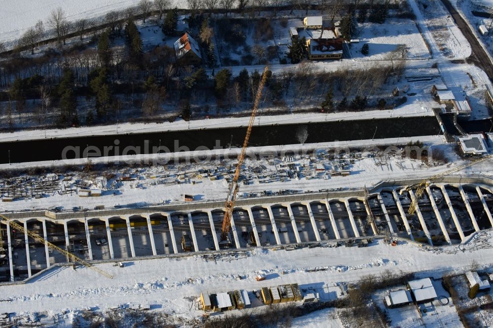 Zerben from above - Wintry snowy construction site at the Zerben sluice, bridge and the riverside of the Elbe-Havel-Canel in the state Saxony-Anhalt