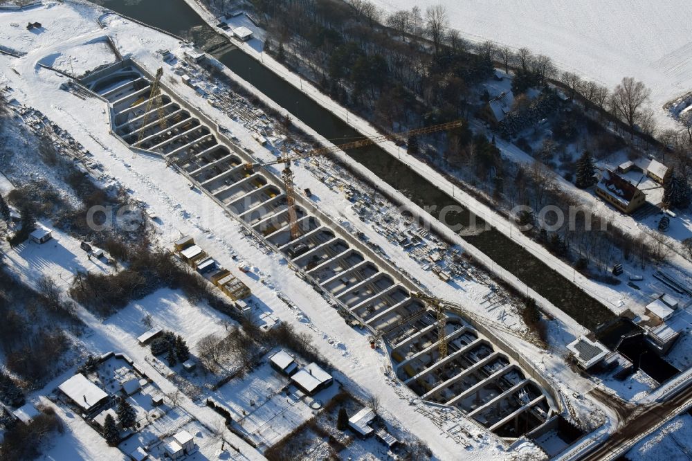 Aerial image Zerben - Wintry snowy construction site at the Zerben sluice, bridge and the riverside of the Elbe-Havel-Canel in the state Saxony-Anhalt