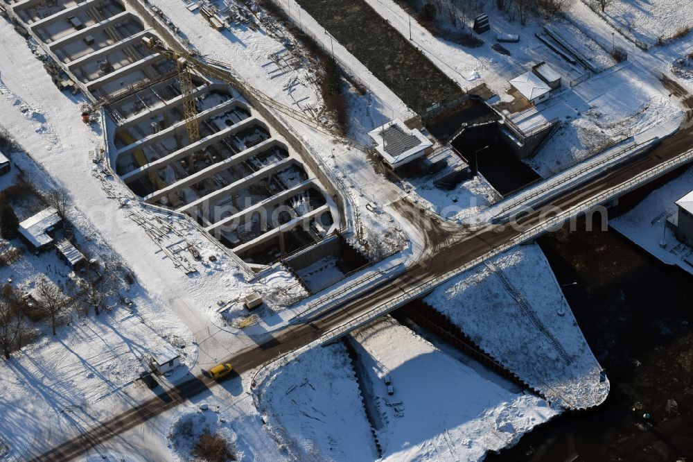 Aerial photograph Zerben - Wintry snowy construction site at the Zerben sluice, bridge and the riverside of the Elbe-Havel-Canel in the state Saxony-Anhalt