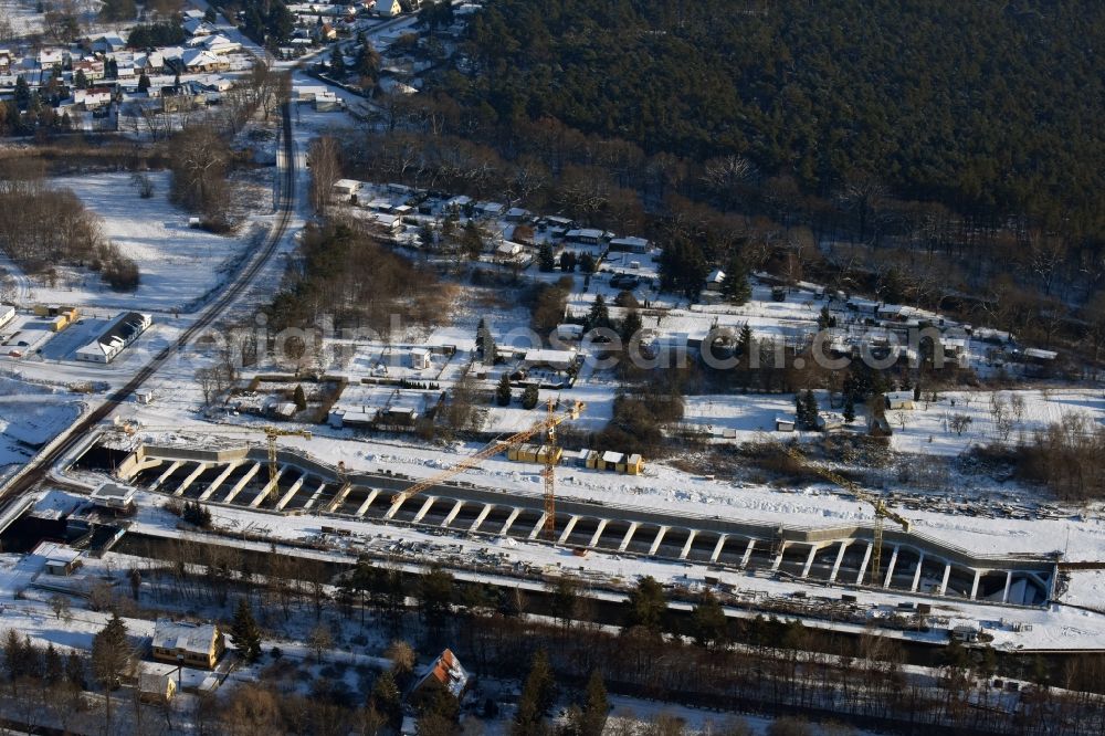 Zerben from the bird's eye view: Wintry snowy construction site at the Zerben sluice, bridge and the riverside of the Elbe-Havel-Canel in the state Saxony-Anhalt